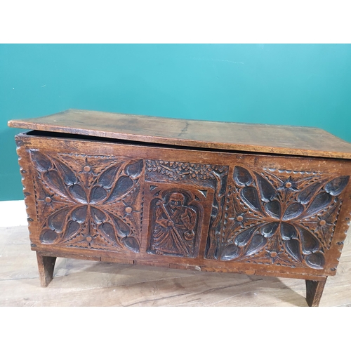 527 - A small carved oak Plank Chest with hinged cover and carved figure to the front, 2ft 8in W