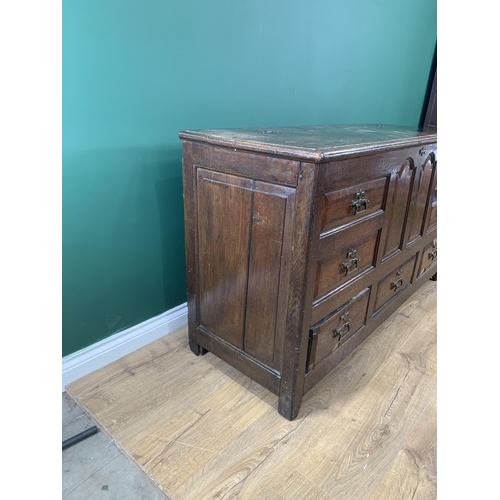 531 - An antique oak Mule Chest with hinged cover, above four dummy and three real drawer below,  5ft 1in