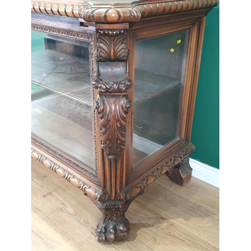 538 - A carved walnut Display Cabinet with bevelled glazed front panel flanked by acanthus leaf pillars wi... 