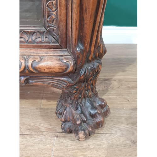 538 - A carved walnut Display Cabinet with bevelled glazed front panel flanked by acanthus leaf pillars wi... 