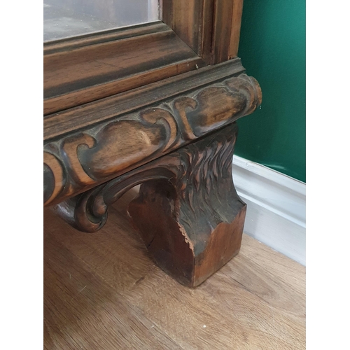 538 - A carved walnut Display Cabinet with bevelled glazed front panel flanked by acanthus leaf pillars wi... 