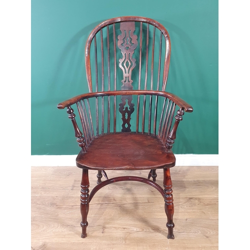 541 - A 19th Century large yew Windsor Elbow Chair with pierced splat back & crinoline stretcher.