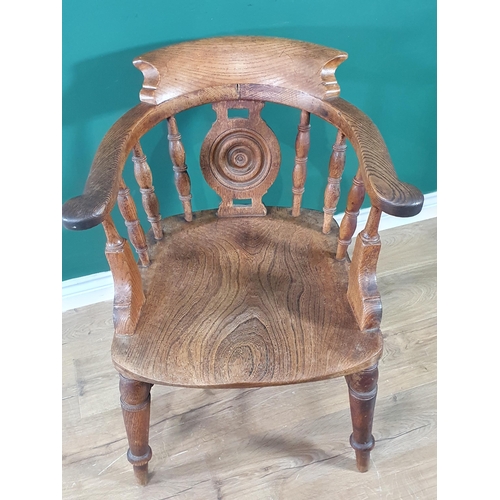 542 - A 19th Century oak and elm Captain's Chair having rounded splat back, shaped seat on turned supports... 