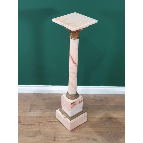 544 - A pink variegated marble Pedestal with square top on cylindrical column with gilt metal capital on s... 