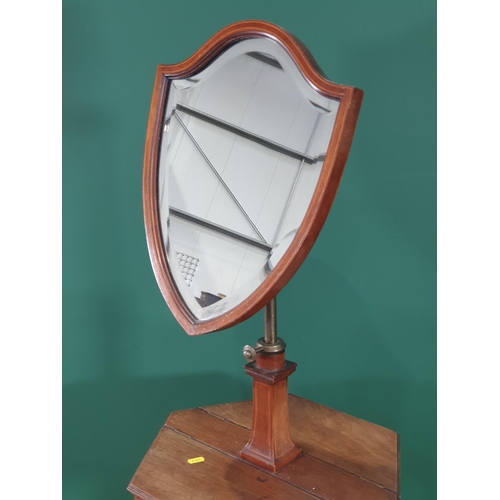 547 - An Edwardian mahogany Shaving Stand with shield-shaped bevelled mirror mounted on hexagonal two comp... 