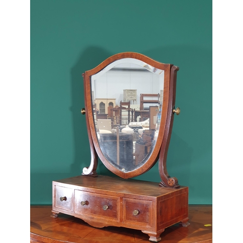 554 - A 19th century mahogany Toilet Mirror with shield-shaped bevelled plate, the inlaid base fitted thre... 