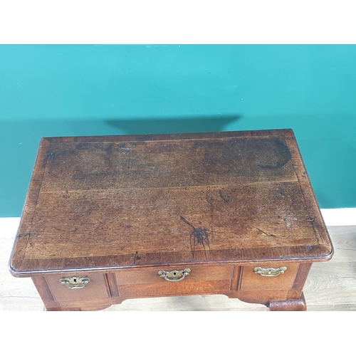 562 - An 18th Century oak Lowboy with crossbanded top fitted three frieze drawers on four cabriole support... 