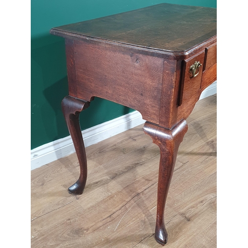 562 - An 18th Century oak Lowboy with crossbanded top fitted three frieze drawers on four cabriole support... 