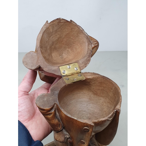 564 - A Treen Tobacco Jar in the form of a Gentleman smoking a Pipe, with Walking Stick, wearing Tricorn H... 