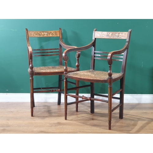 565 - A pair of 19th Century ash Elbow Chairs with floral painted bar-backs and rush seats raised on turne... 