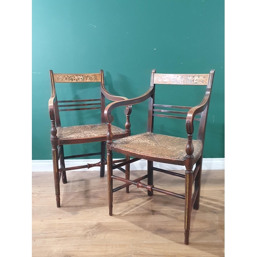 565 - A pair of 19th Century ash Elbow Chairs with floral painted bar-backs and rush seats raised on turne... 