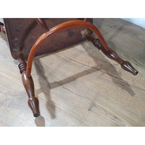 566 - A 19th Century ash and yew Windsor Elbow Chair with pierced splat back raised on turned supports uni... 