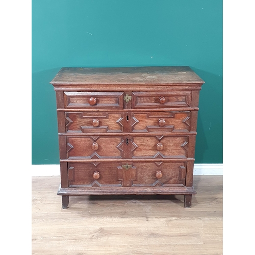 570 - A 17th Century oak Chest fitted two short and three long drawers with geometric mouldings and turned... 