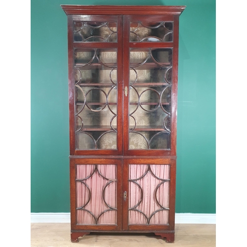 573 - A George III mahogany Bookcase fitted two pairs of glazed doors enclosing adjustable shelves, the bo... 