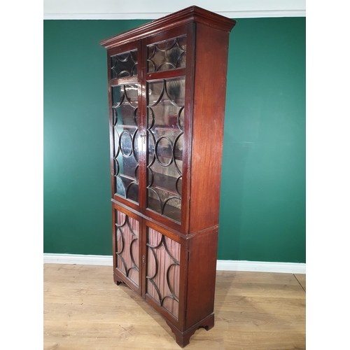 573 - A George III mahogany Bookcase fitted two pairs of glazed doors enclosing adjustable shelves, the bo... 