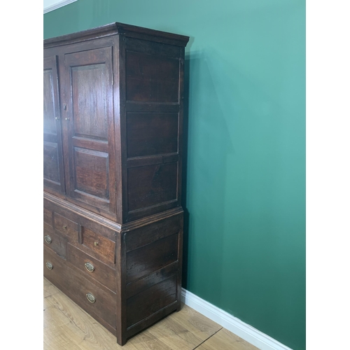 579 - An 18th Century oak Bacon Cupboard with pair of panelled doors enclosing wooden hooks, above three d... 