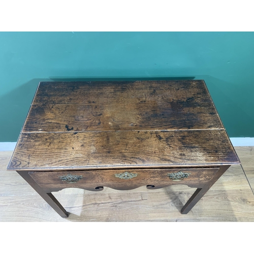 581 - An 18th Century oak Side Table fitted frieze drawer above a scroll shaped frieze and raised on chamf... 