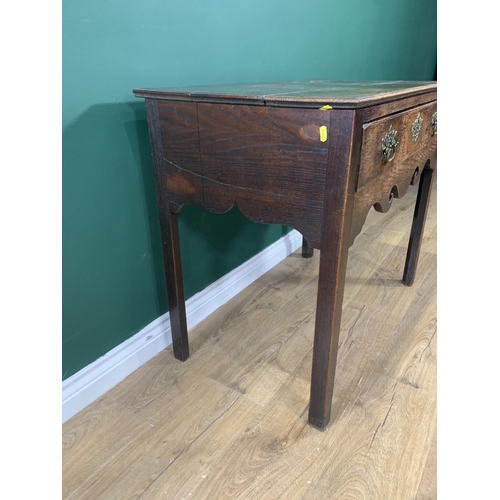 581 - An 18th Century oak Side Table fitted frieze drawer above a scroll shaped frieze and raised on chamf... 