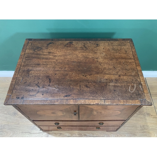 582 - A 19th Century mahogany Chest with oval panelled cupboard doors above two graduated drawers on brack... 