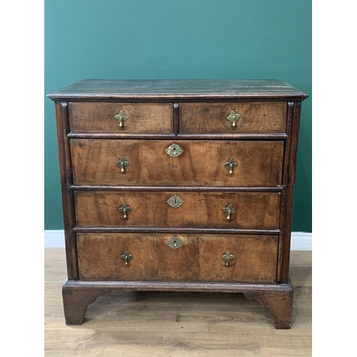 583 - An 18th Century walnut and oak Chest of two short and three long graduated drawers on bracket suppor... 