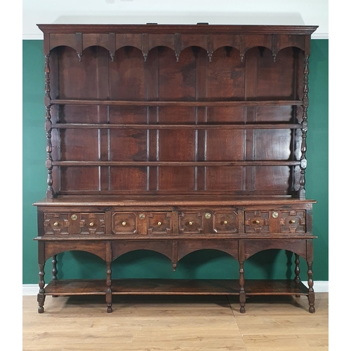 585 - A large 18th Century oak Dresser and Rack, the shelves to the rack with baluster turned supports, th... 