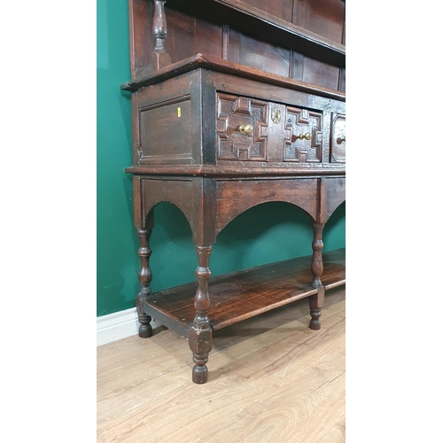 585 - A large 18th Century oak Dresser and Rack, the shelves to the rack with baluster turned supports, th... 