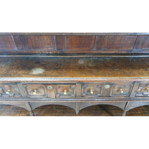 585 - A large 18th Century oak Dresser and Rack, the shelves to the rack with baluster turned supports, th... 