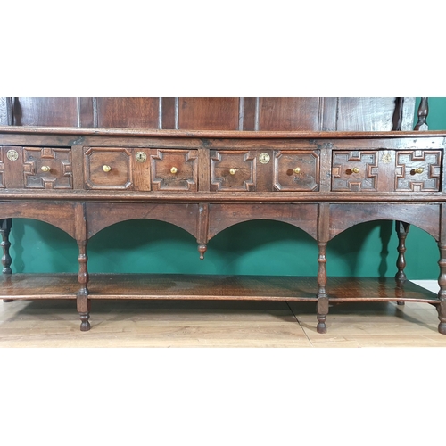 585 - A large 18th Century oak Dresser and Rack, the shelves to the rack with baluster turned supports, th... 