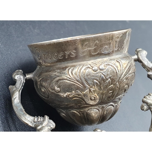 59 - A George V silver Wager Cup with floral and leafage scroll decoration,inscribed Grocers Hall 1910, L... 