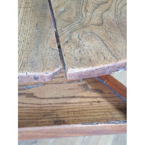 590 - An 18th Century elm Cricket Table with two piece circular top mounted on triangular supports united ... 