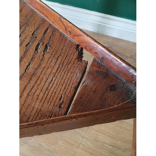 590 - An 18th Century elm Cricket Table with two piece circular top mounted on triangular supports united ... 