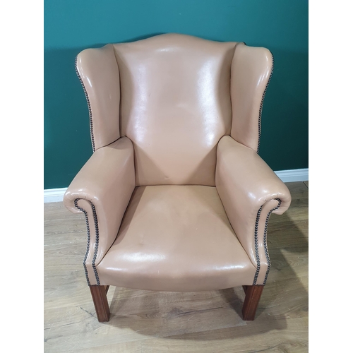 596 - A Georgian style Wingback Library Chair with studded detail and raised on moulded squared front supp... 