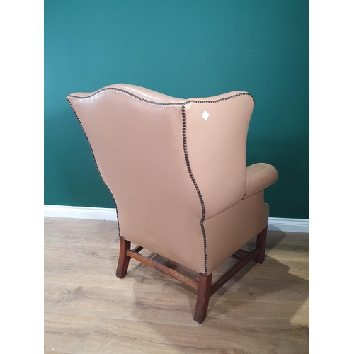 596 - A Georgian style Wingback Library Chair with studded detail and raised on moulded squared front supp... 