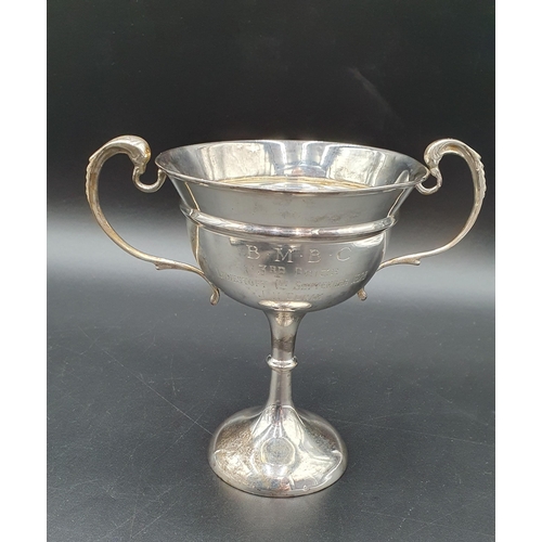 6 - A George V silver two handled Trophy with presentation inscription on single knop stem, London 1928,... 