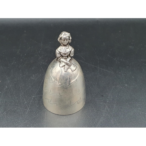 60 - A George V silver Crinoline Bell with engraved decoration, the clappers modeled as two legs, London ... 