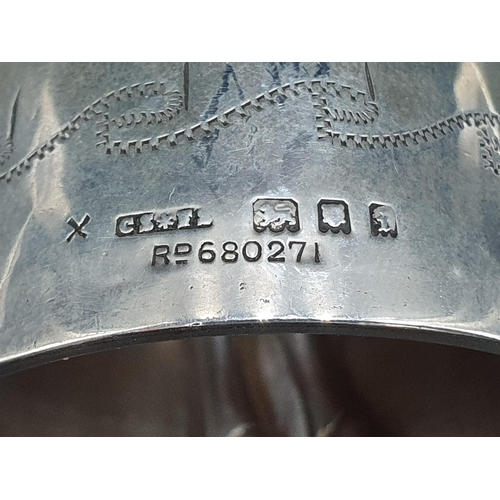 60 - A George V silver Crinoline Bell with engraved decoration, the clappers modeled as two legs, London ... 