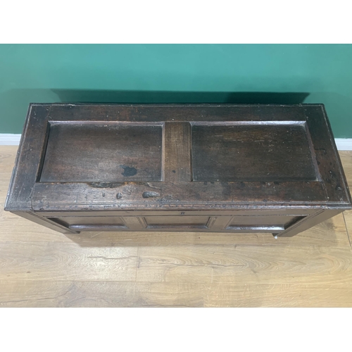 605 - A 17th Century oak Coffer with hinged panelled top and panelled front, 4ft 1in W x 1ft 9in H