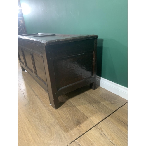 605 - A 17th Century oak Coffer with hinged panelled top and panelled front, 4ft 1in W x 1ft 9in H