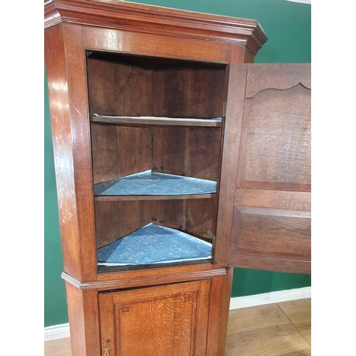 606 - An antique oak double Corner Cupboard, the upper door with cupid's bow and chequered strung panelled... 