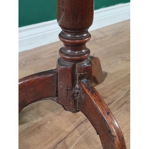 609 - An antique oak Tripod Table with circular top on baluster column, 20in diam, (old repair to top)