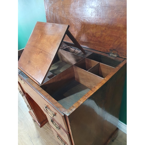 612 - A George III walnut Kneehole Desk with feather banded and quarter-veneered hinged top opening to rev... 