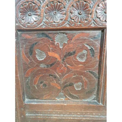 615 - An 18th Century oak Coffer with panelled hinged top, flower head carved frieze above inlaid panels, ... 