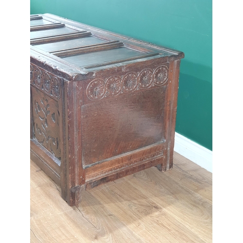 615 - An 18th Century oak Coffer with panelled hinged top, flower head carved frieze above inlaid panels, ... 