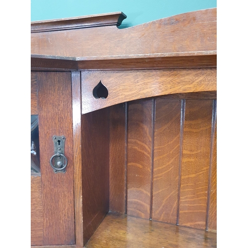 628 - An Arts and Crafts oak Dresser, the upper section fitted a pair of glazed door, the lower section fi... 