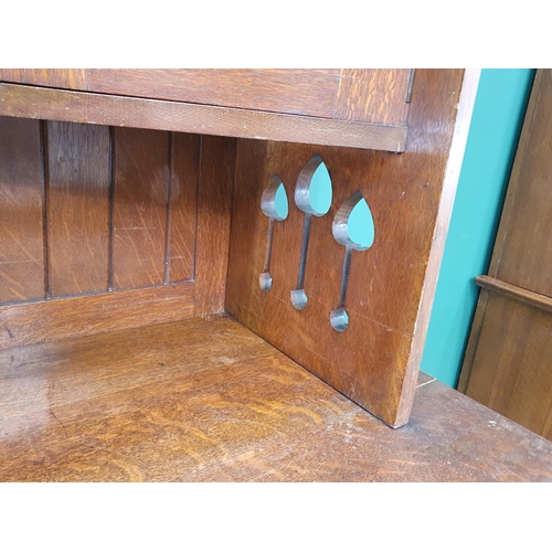 628 - An Arts and Crafts oak Dresser, the upper section fitted a pair of glazed door, the lower section fi... 