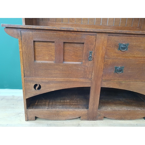 628 - An Arts and Crafts oak Dresser, the upper section fitted a pair of glazed door, the lower section fi... 