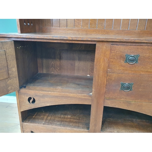 628 - An Arts and Crafts oak Dresser, the upper section fitted a pair of glazed door, the lower section fi... 