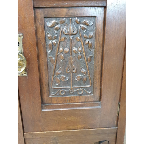 629 - An oak Art Nouveau Mirrorback Sideboard, the upper section with a pair of inlaid doors, the base fit... 