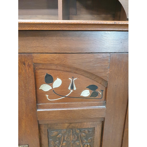 629 - An oak Art Nouveau Mirrorback Sideboard, the upper section with a pair of inlaid doors, the base fit... 