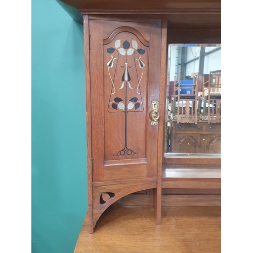 629 - An oak Art Nouveau Mirrorback Sideboard, the upper section with a pair of inlaid doors, the base fit... 